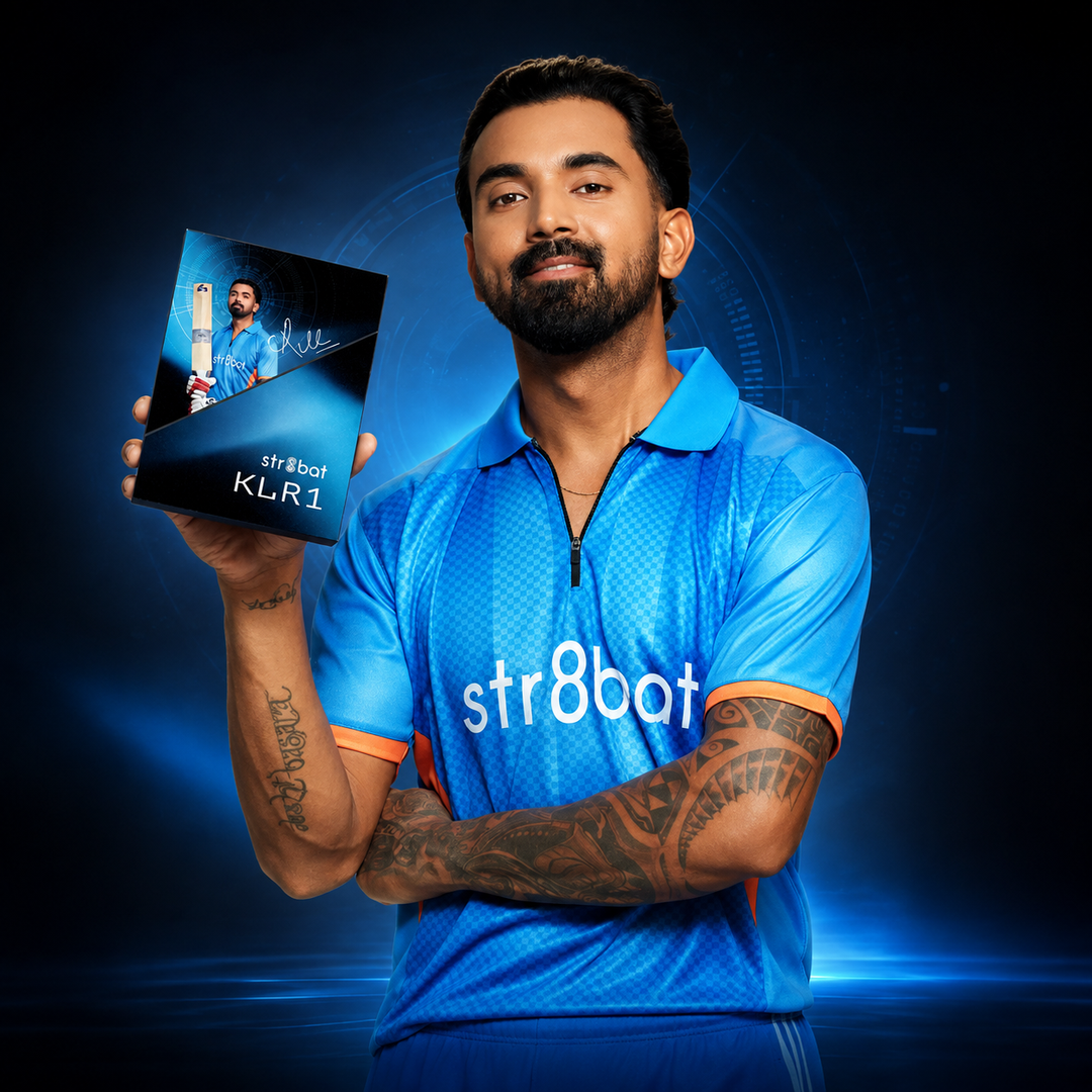 A man KL RAHUL in a blue 'str8bat' sports jersey holds up a black product box labelled 'str8bat KLR1' against a dark blue, high-tech background.